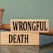 WRONGFUL DEATH - words on wooden blocks with a judge's gavel in the background